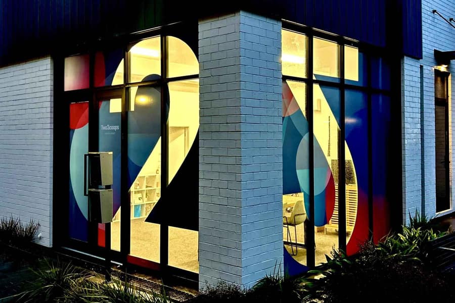 The TwoScoops Creative Agency office window in Ōtautahi Christchurch, lit up at dusk